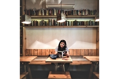 Image A student studies in a library.